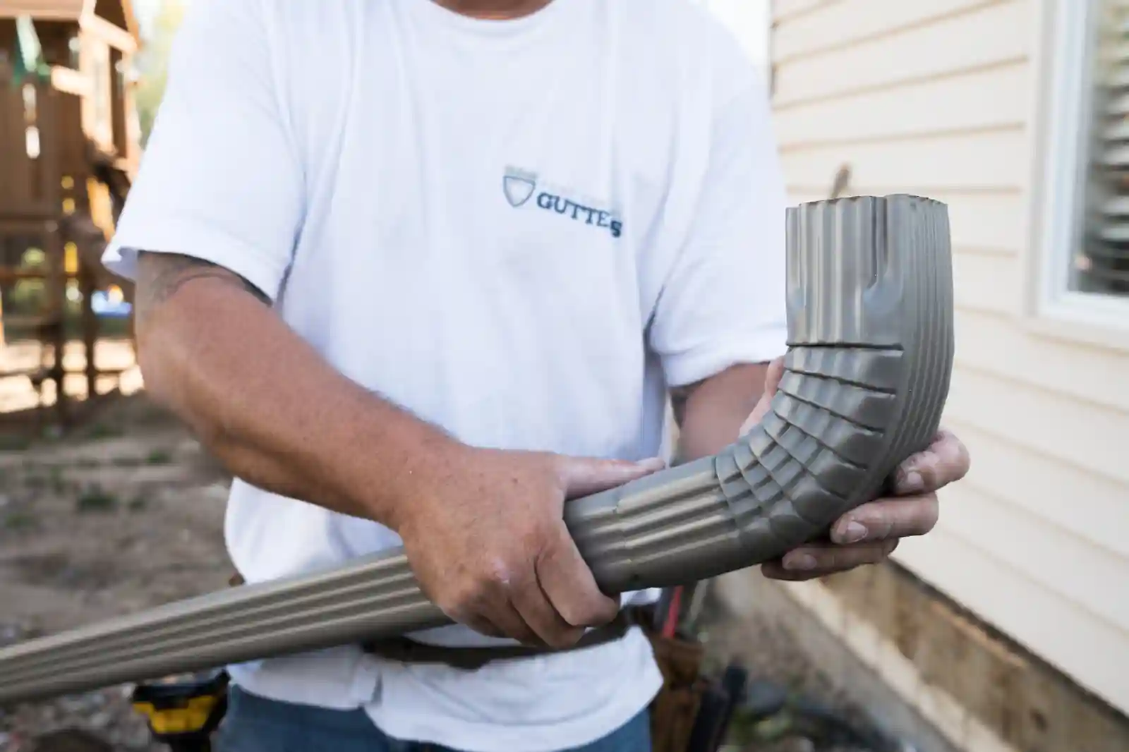 Technician repairing damaged gutter section